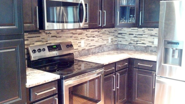 New kitchen counter, cabinets, tile backsplash and appliances