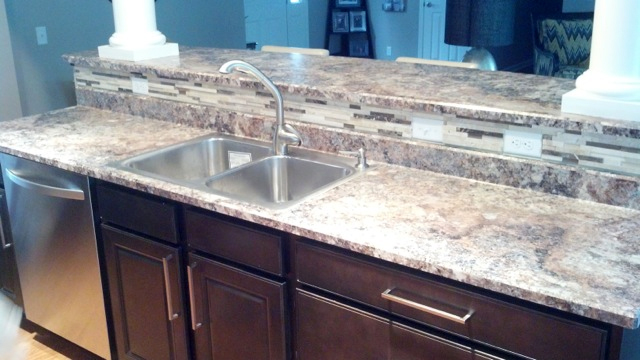 New kitchen counter island with cabinets and sink